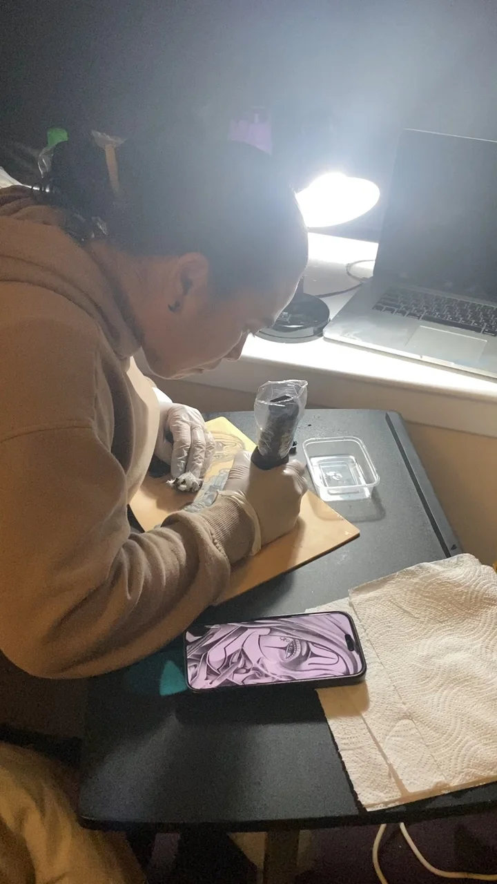 Nat working on the practice sheet beside her reference image